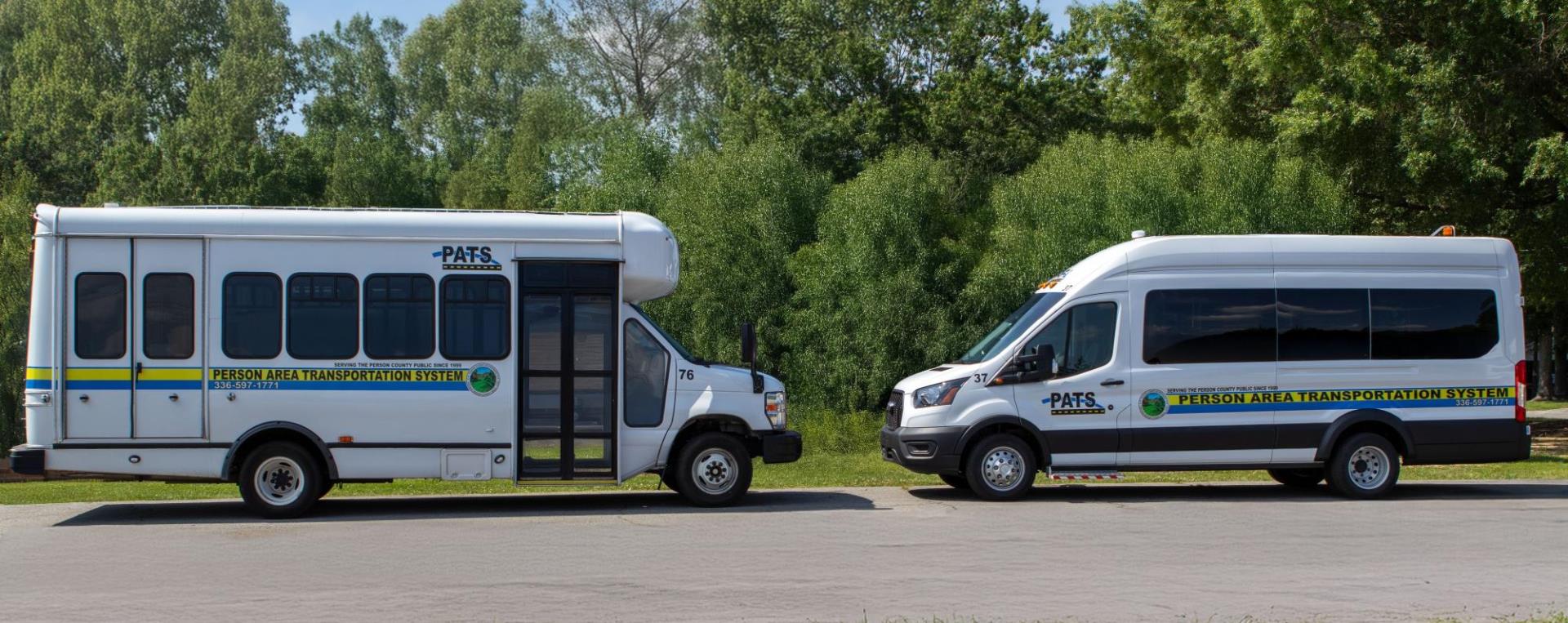 Image of a Transit Bus and a Transit Van facing each other